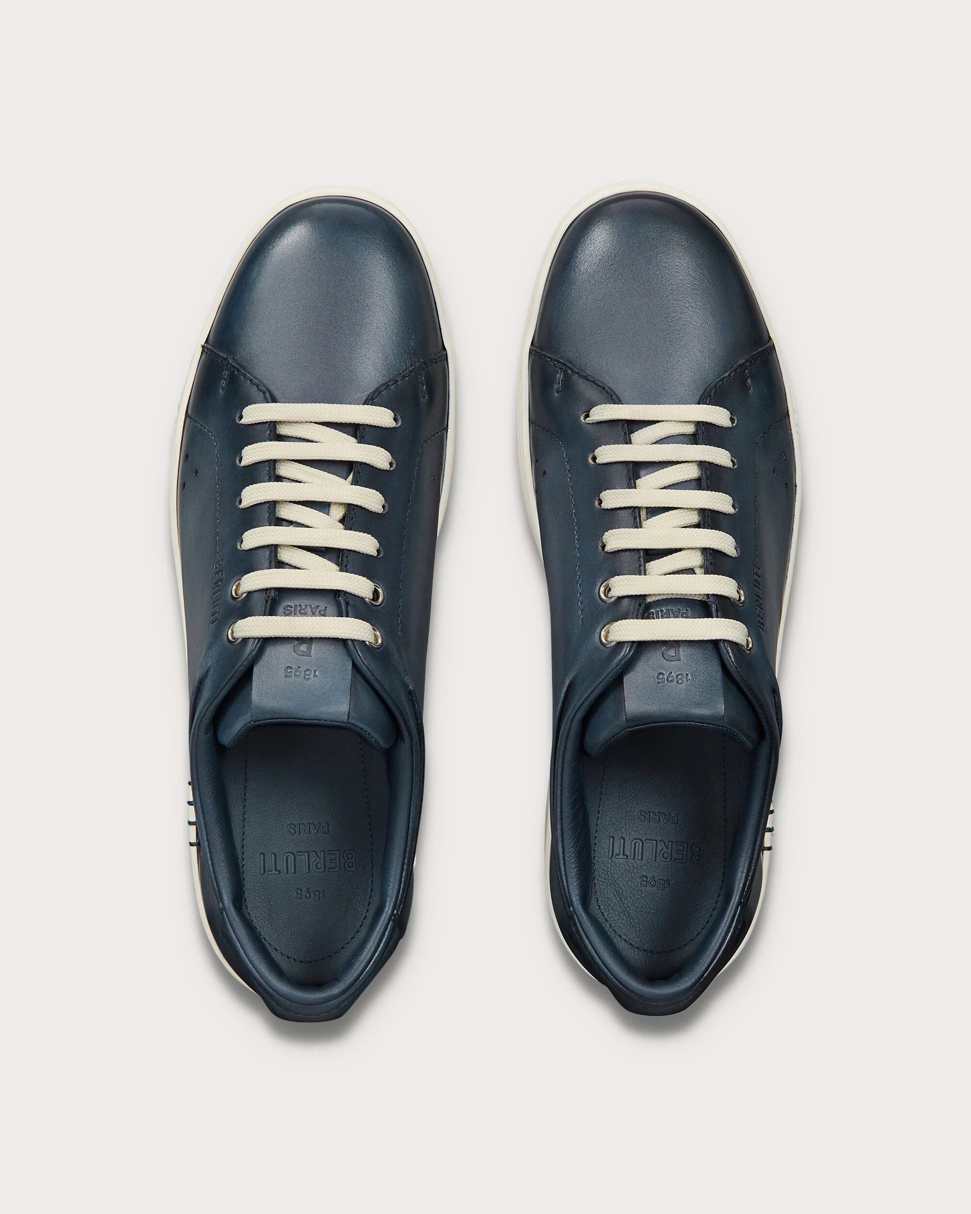 Berluti Playtime sneakers feature navy blue Venezia leather and signature hand
