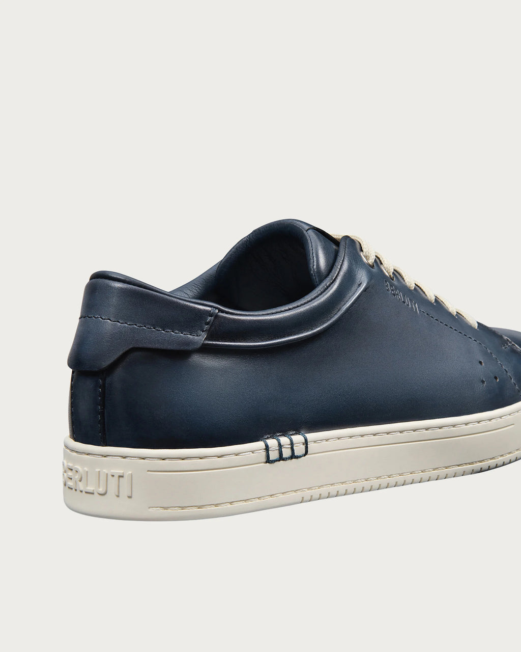 Berluti Playtime sneakers feature navy blue Venezia leather and signature hand